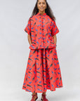 Model wearing red cat print shirt and culotte.