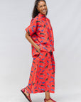 Model wearing red cat print shirt and culotte.