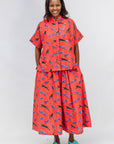 Model wearing red cat print shirt and culotte.