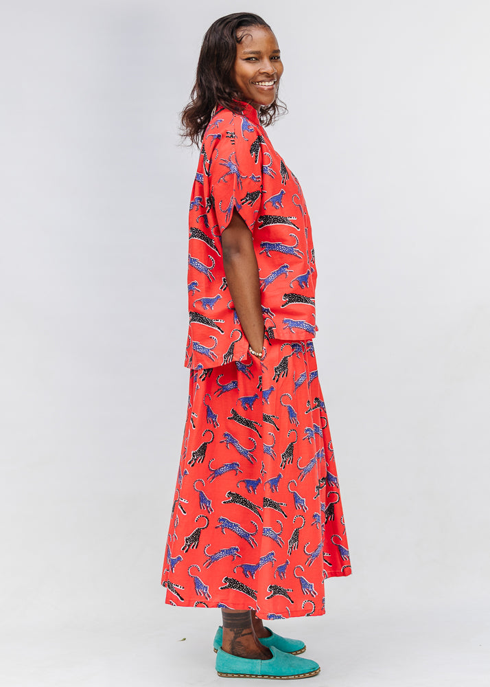 Model wearing red cat print shirt and culotte.