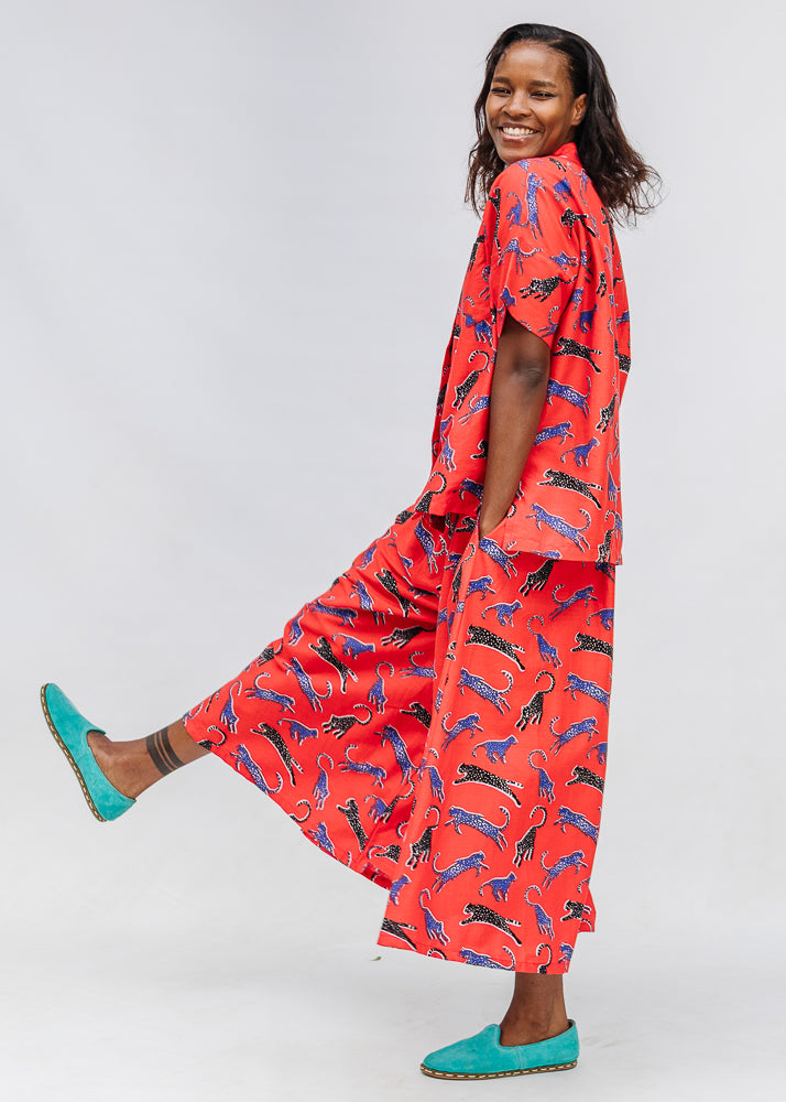 Model wearing red cat print shirt and culotte.