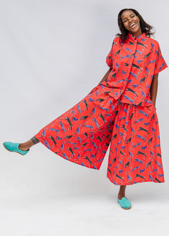 Model wearing red cat print shirt and culotte.