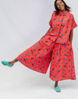 Model wearing red cat print shirt and culotte.