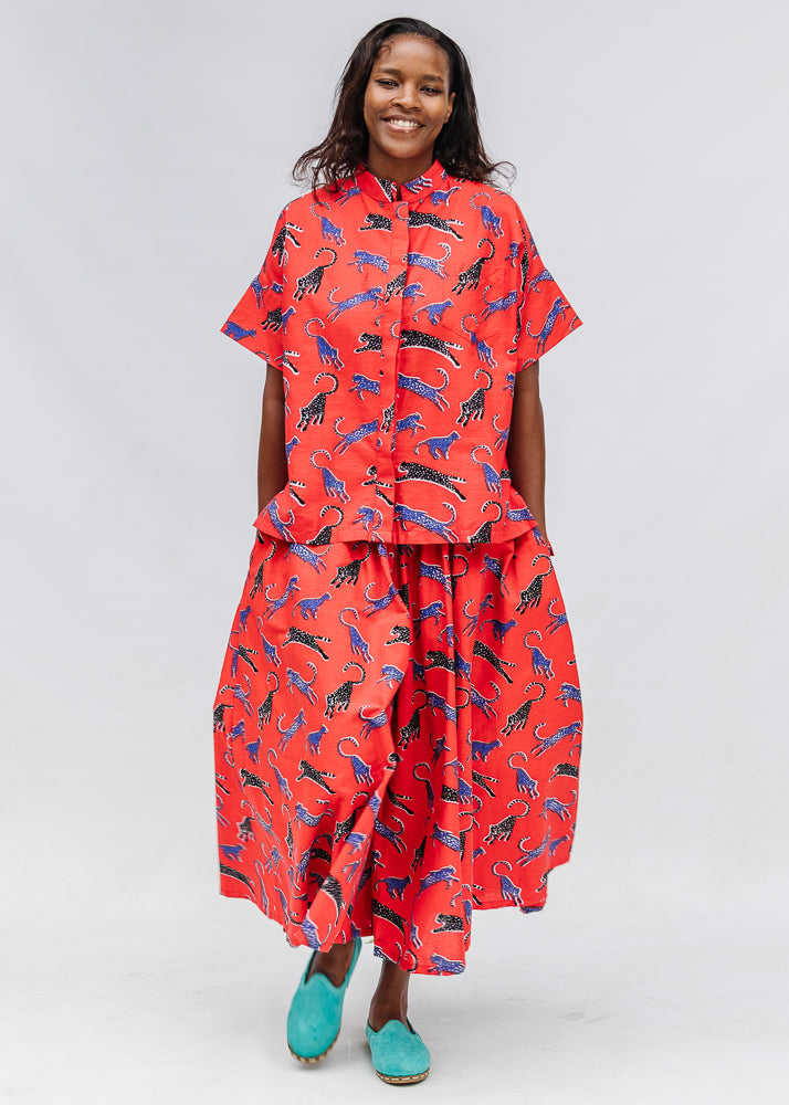 Model wearing red cat print shirt and culotte.