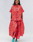 Model wearing red cat print shirt and culotte.