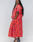 Model wearing red cat print shirt and culotte.
