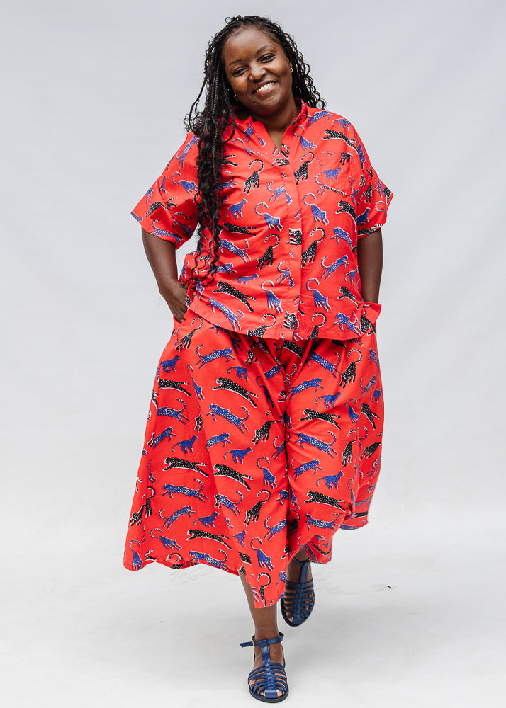 Model wearing red cat print shirt and culotte.