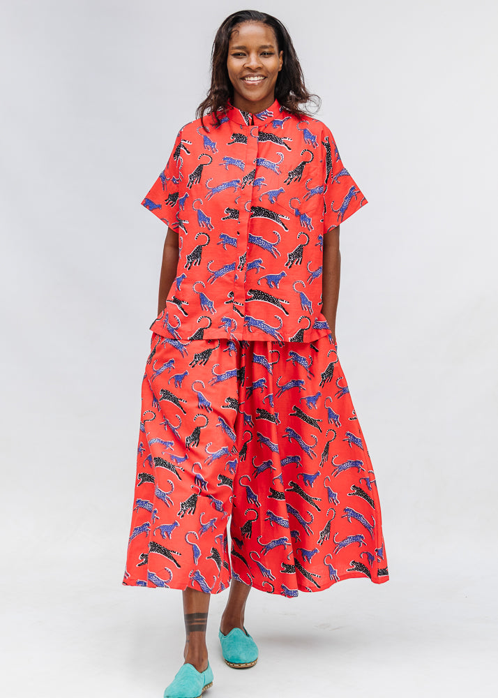Model wearing red cat print shirt and culotte.
