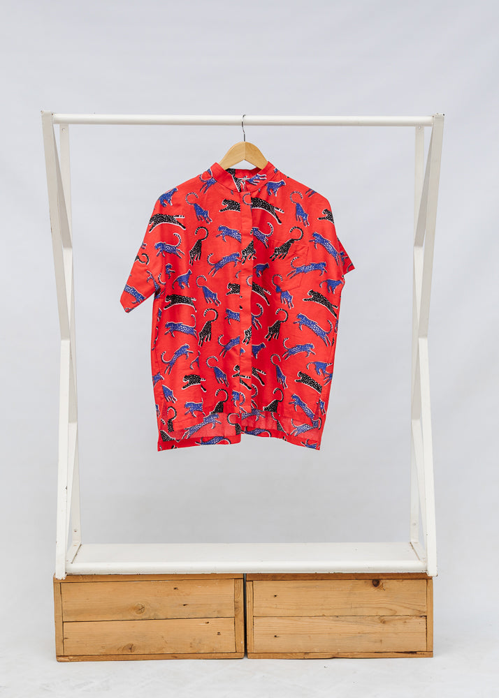 Display of red cat print shirt.
