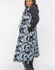 Model wearing navy and gray abstract print maxi dress.