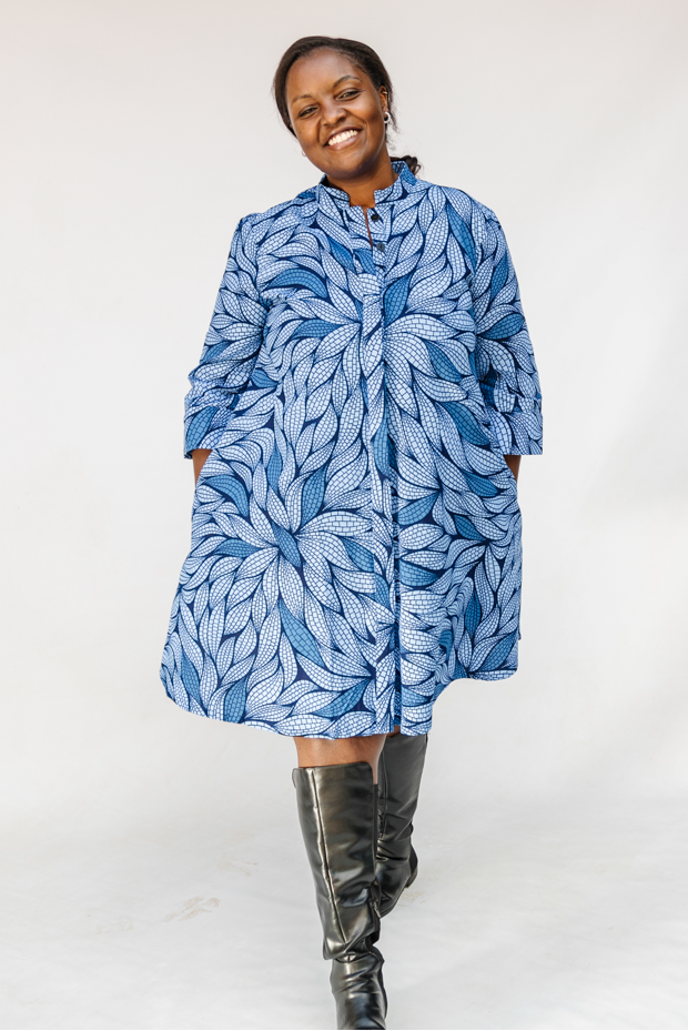 Model wearing blue shaded leaf print dress.