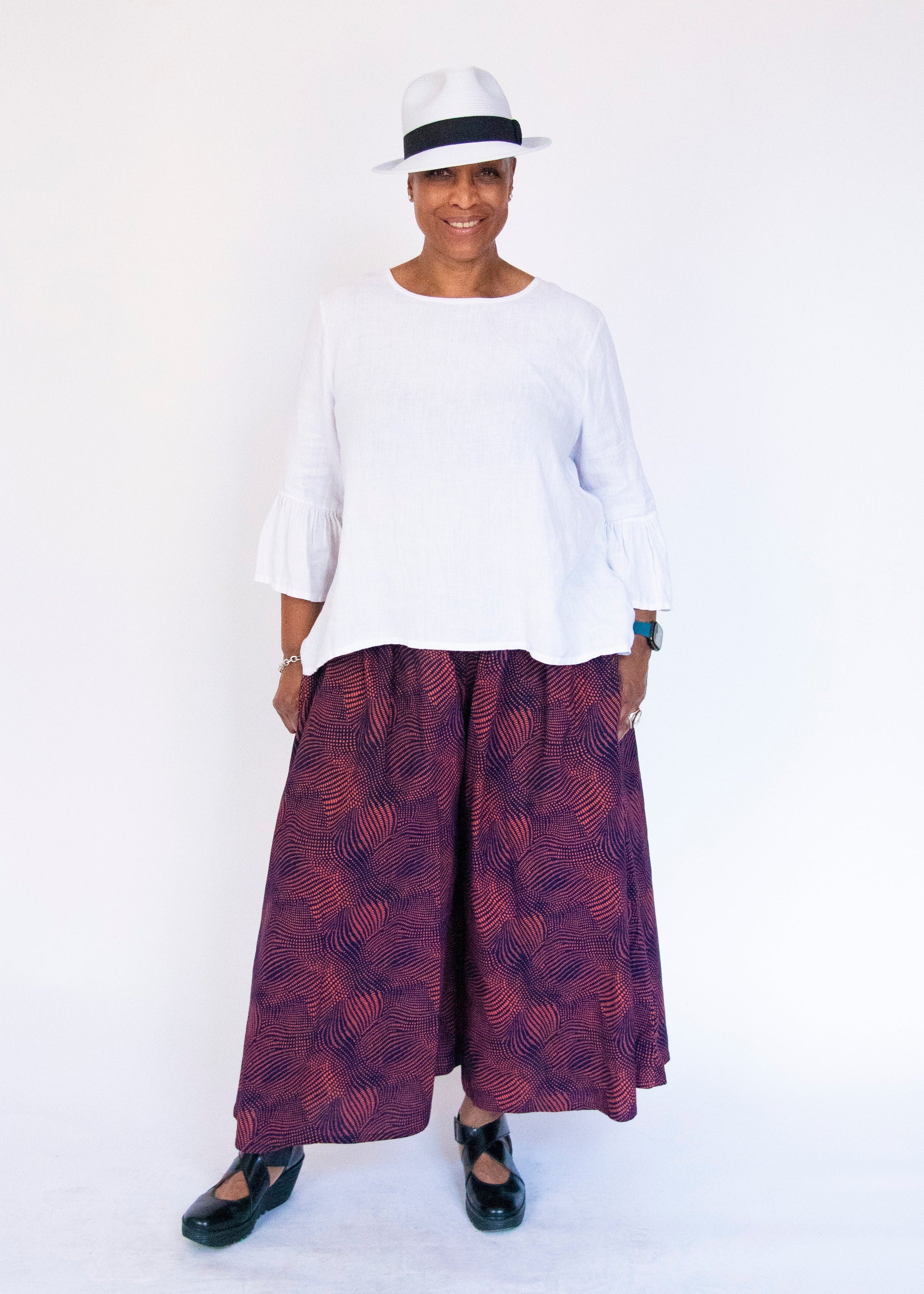 Model wearing navy pants with pink dots.