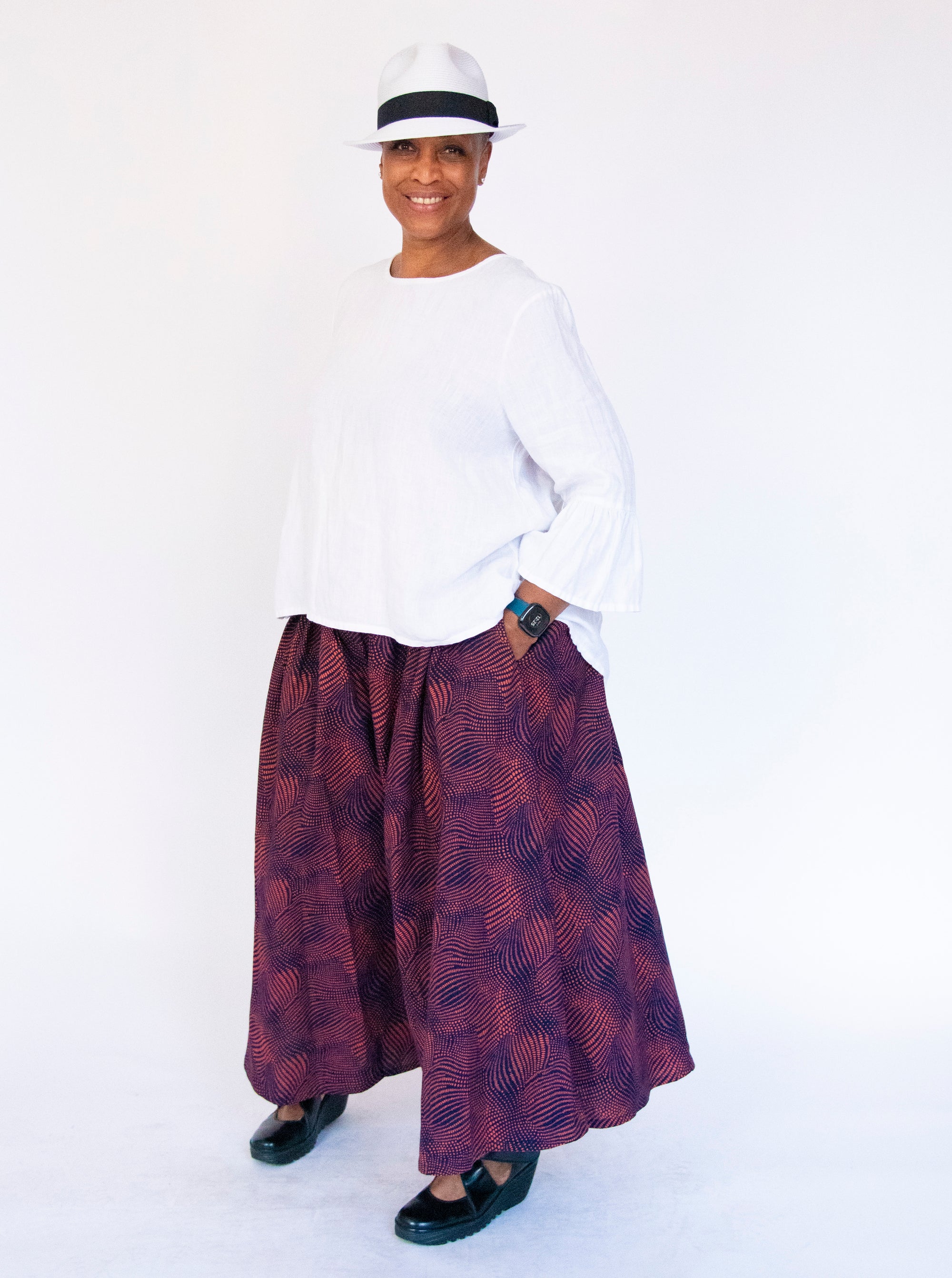 Model wearing navy pants with pink dots.