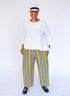 Model wearing yellow pants with blue zig zag pattern.