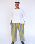Model wearing yellow pants with blue zig zag pattern.