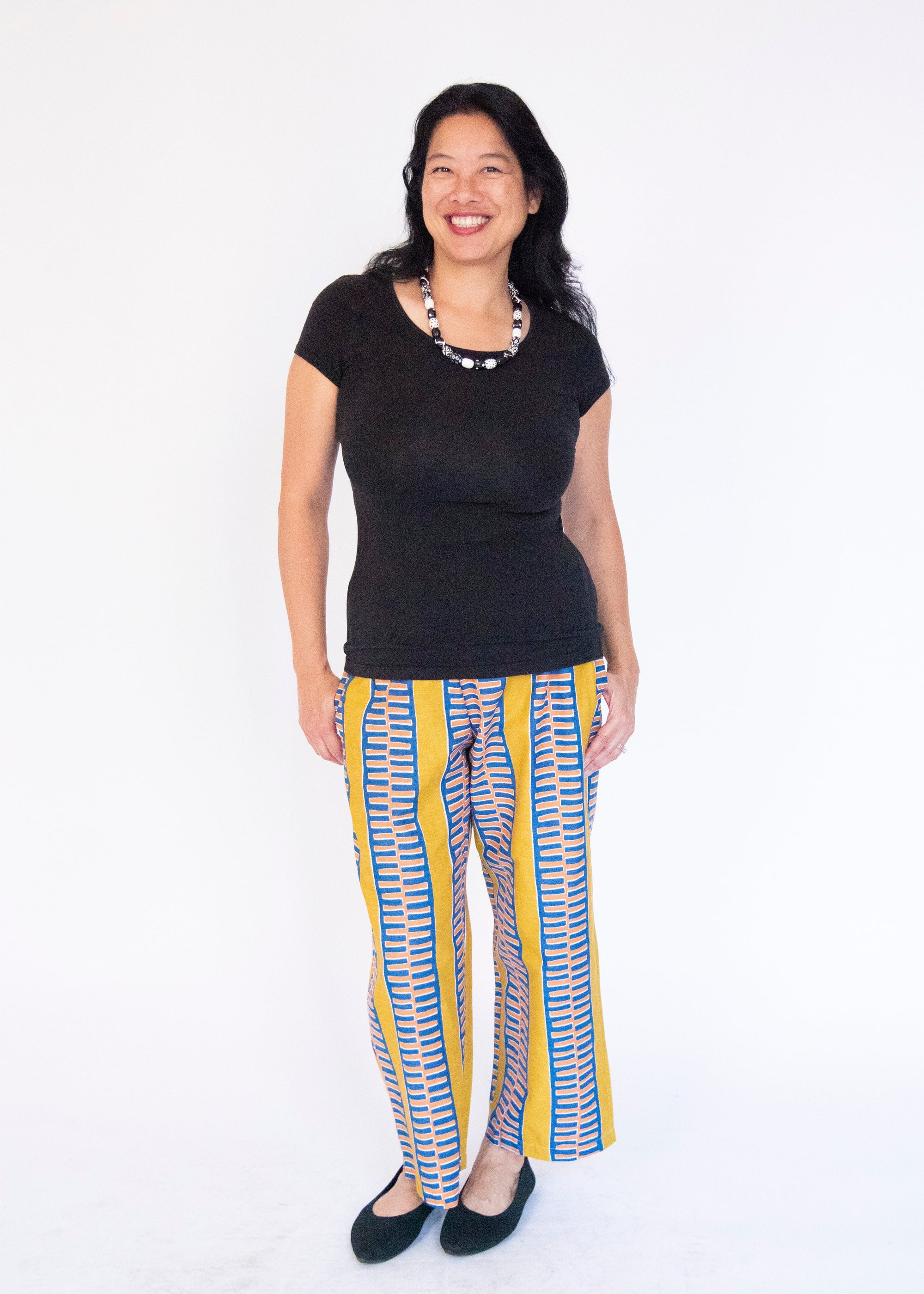 Model wearing yellow pants with blue stripe.