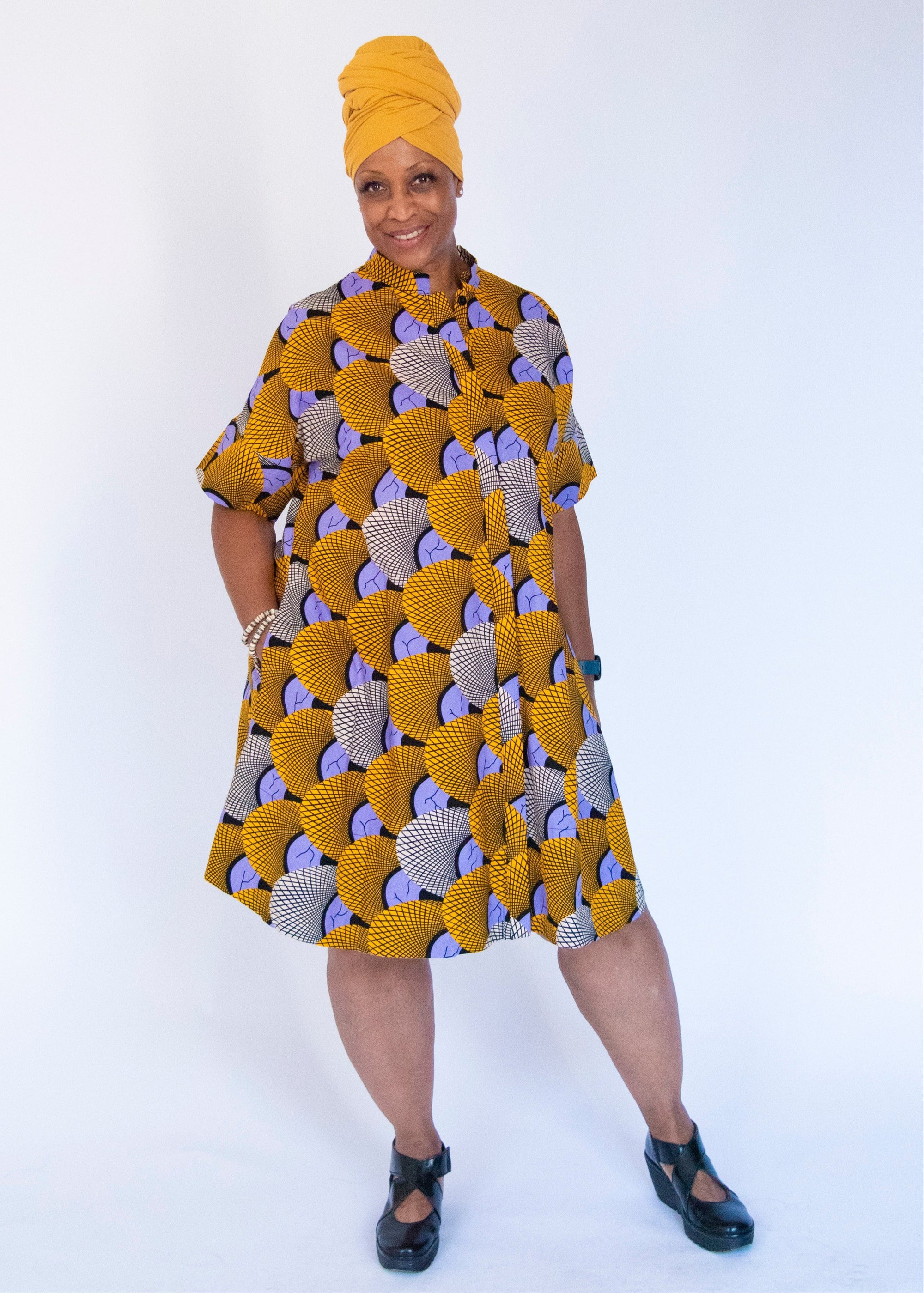 Model wearing orange and purple dress.