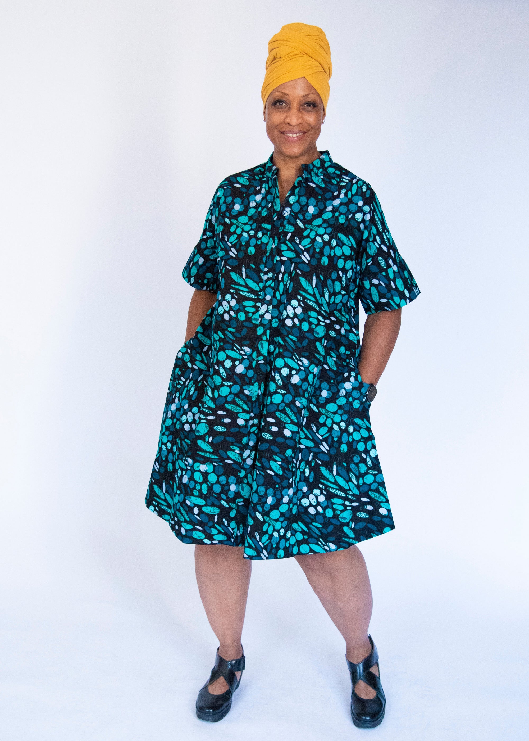 Model wearing abstract blue pebble print dress.