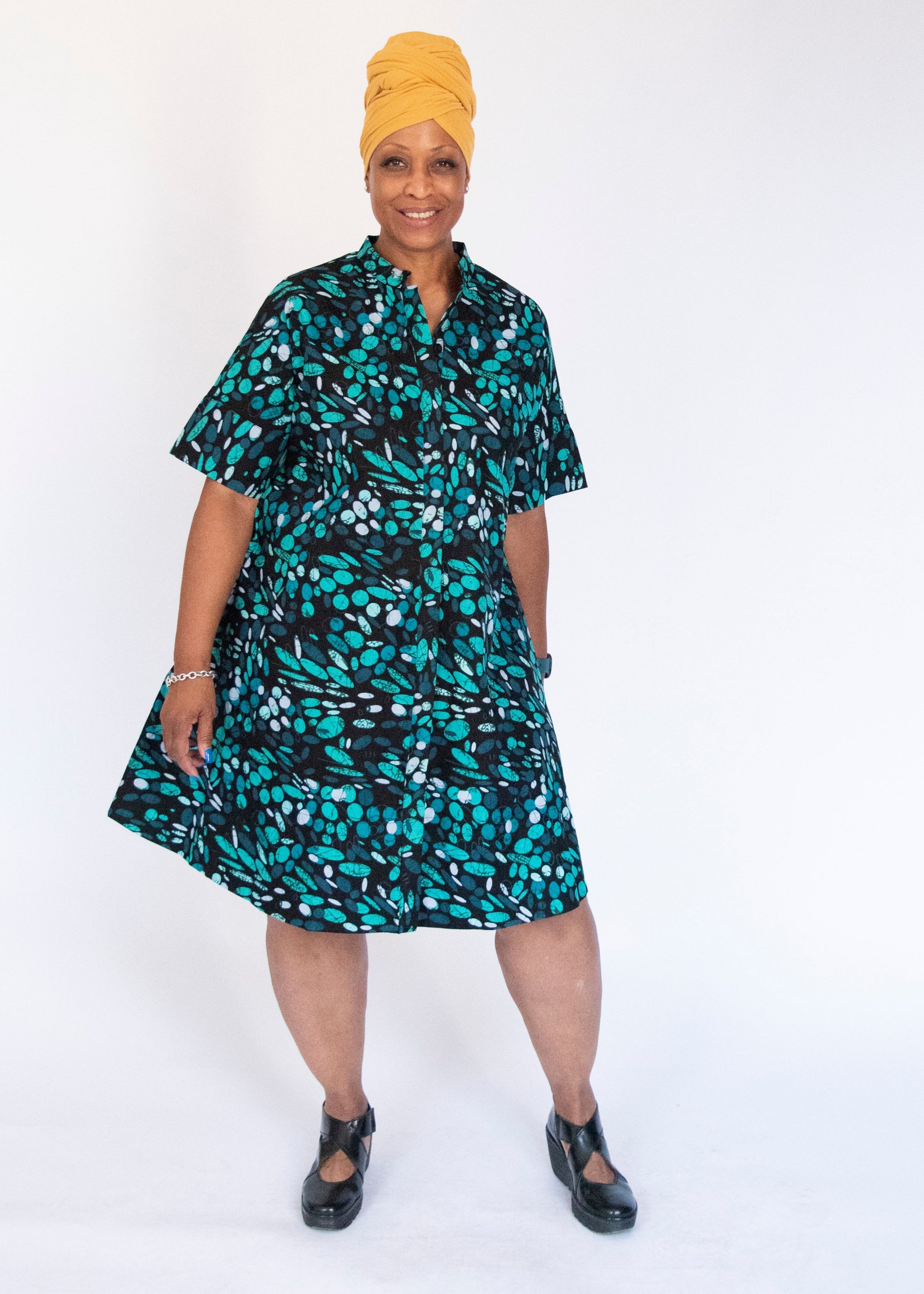 Model wearing abstract blue pebble print dress.