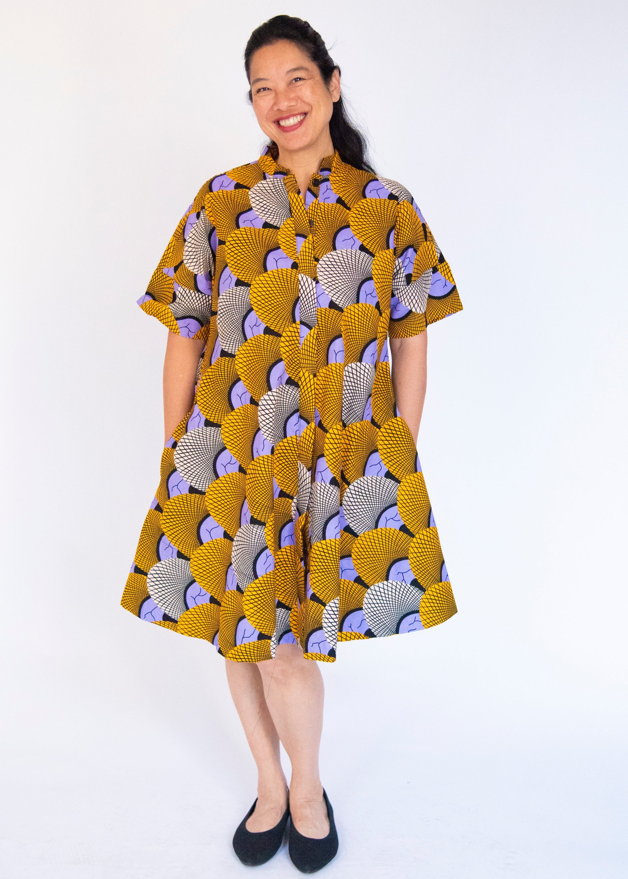 Model wearing orange and purple dress.