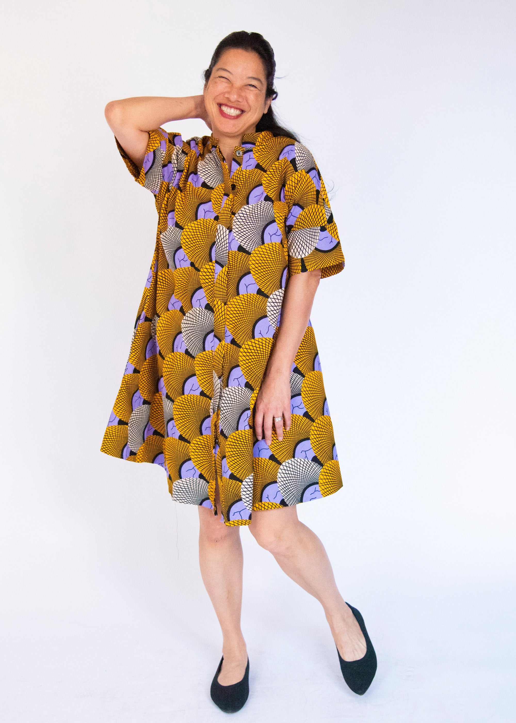 Model wearing orange and purple dress.