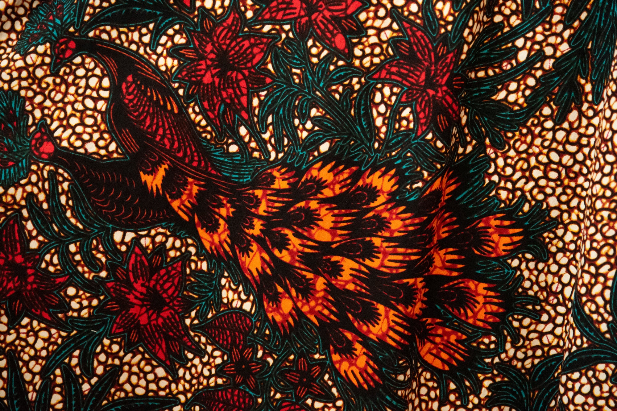 Close up display of orange, brown and green dress, fabric.