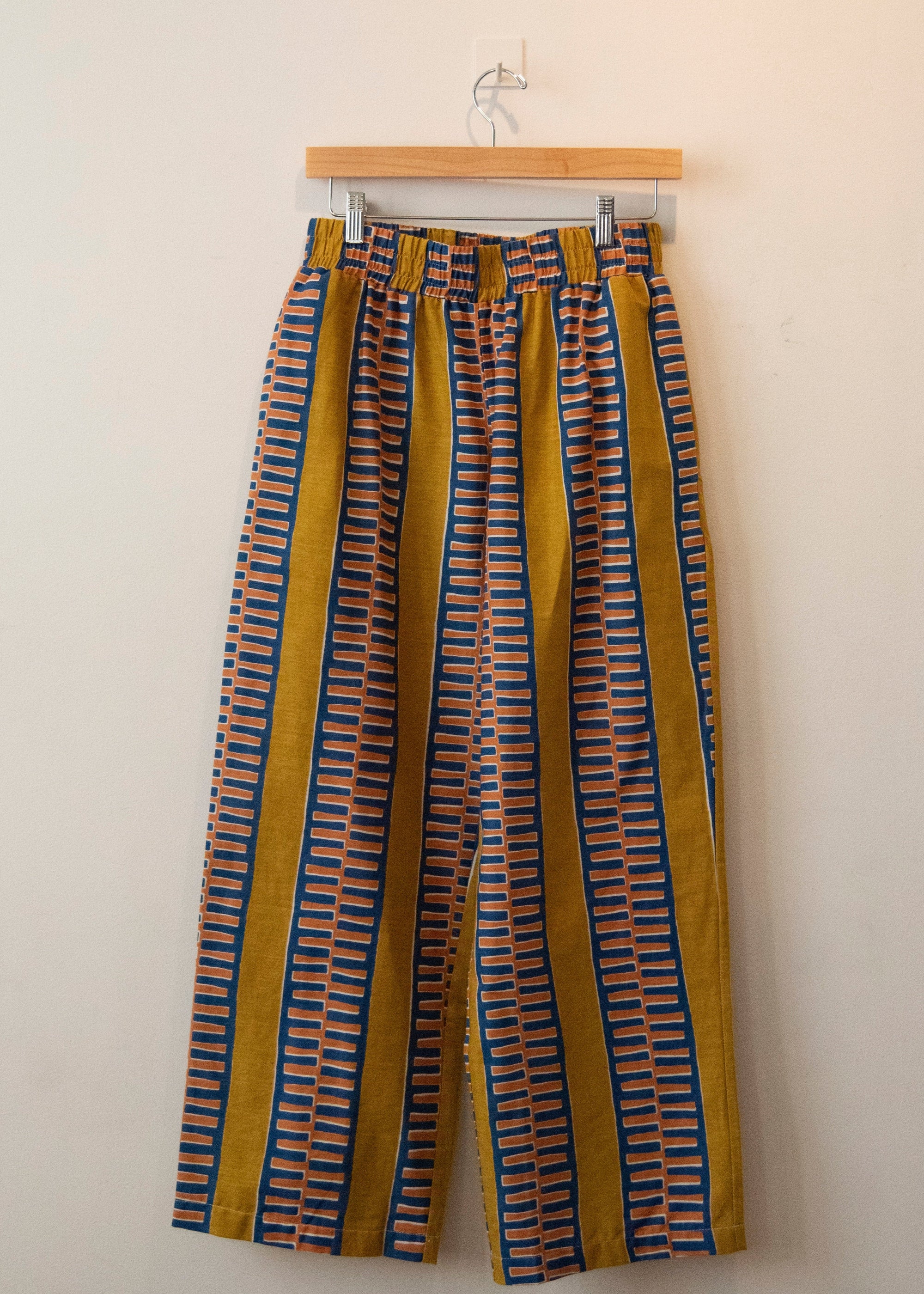 Display of yellow pants with blue zig zag pattern.