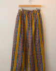 Display of yellow pants with blue zig zag pattern.
