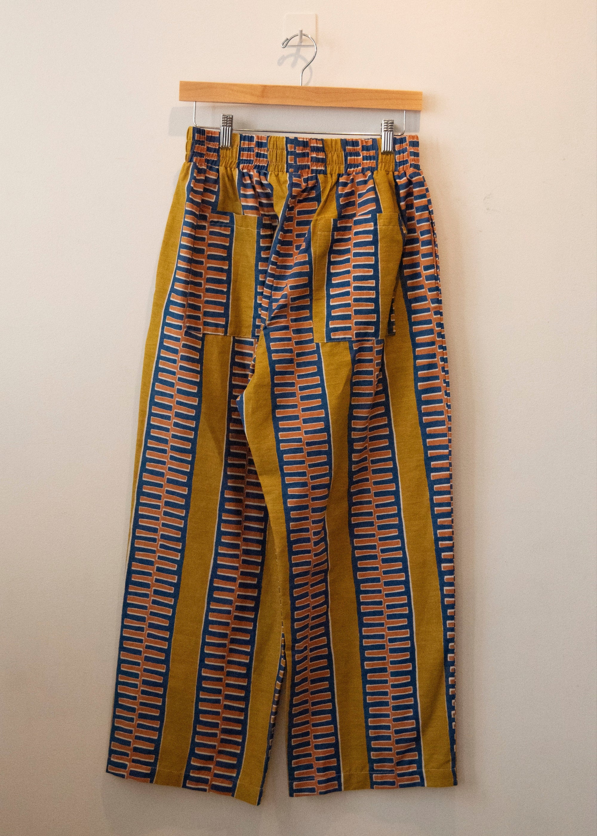 Display of yellow pants with blue zig zag pattern.