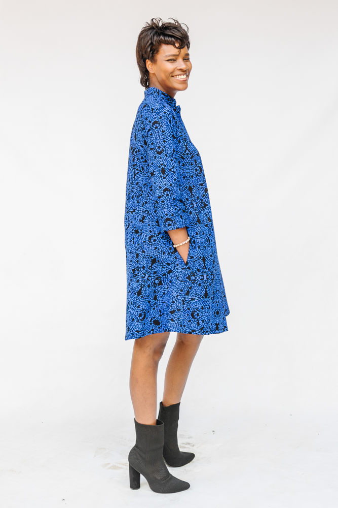 Model wearing black and blue floral dress.