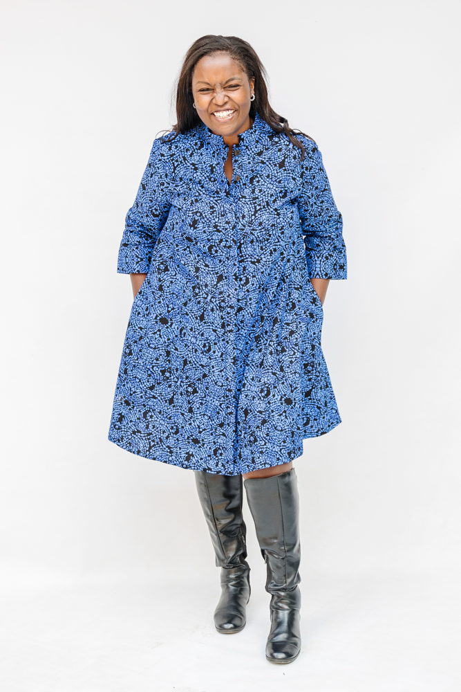 Model wearing black and blue floral dress.