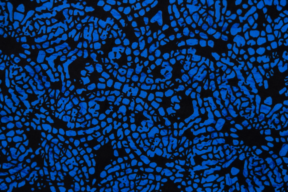 Close up display of black and blue floral dress, fabric.