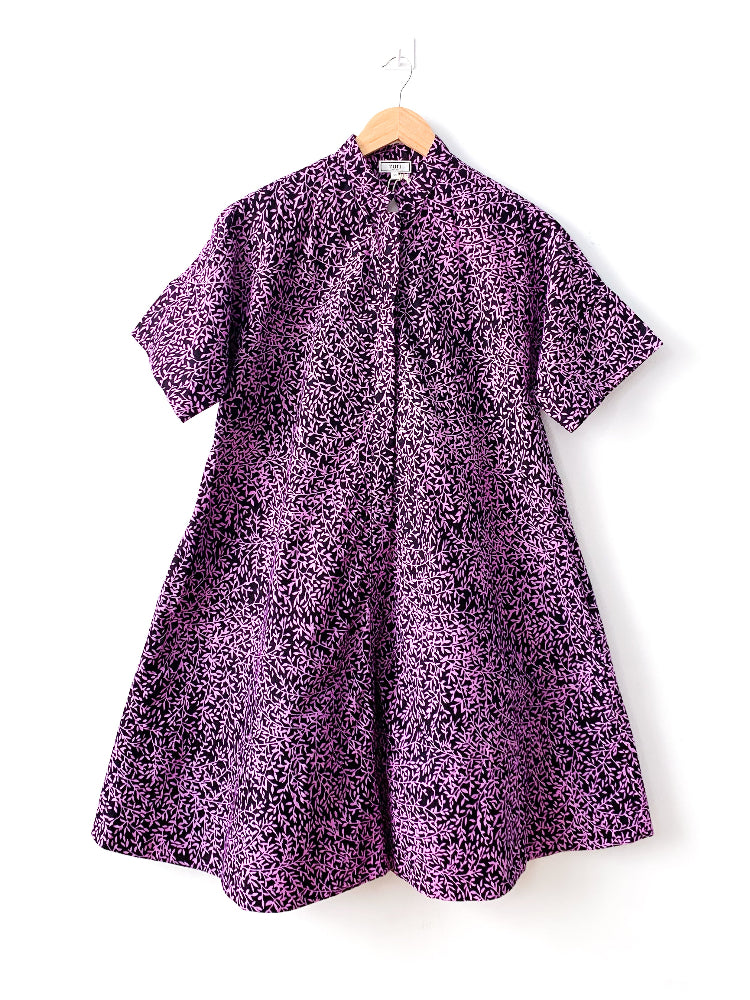 Display of purple and black floral print dress.