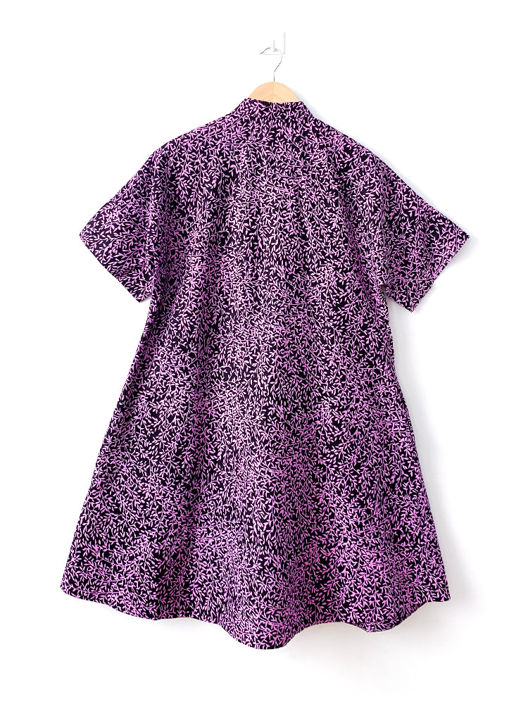 Display of purple and black floral print dress.