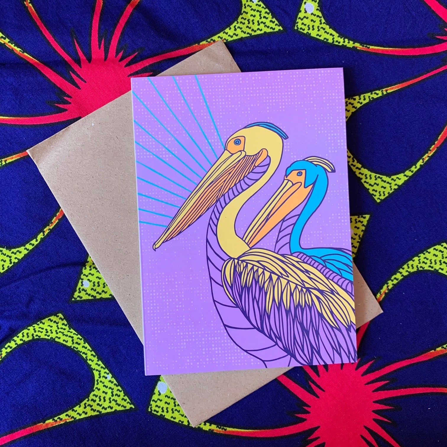 Lavender colored greeting card with two pelicans