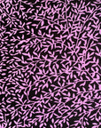 Close up display of black and purple floral print sleeveless shirt, fabric.