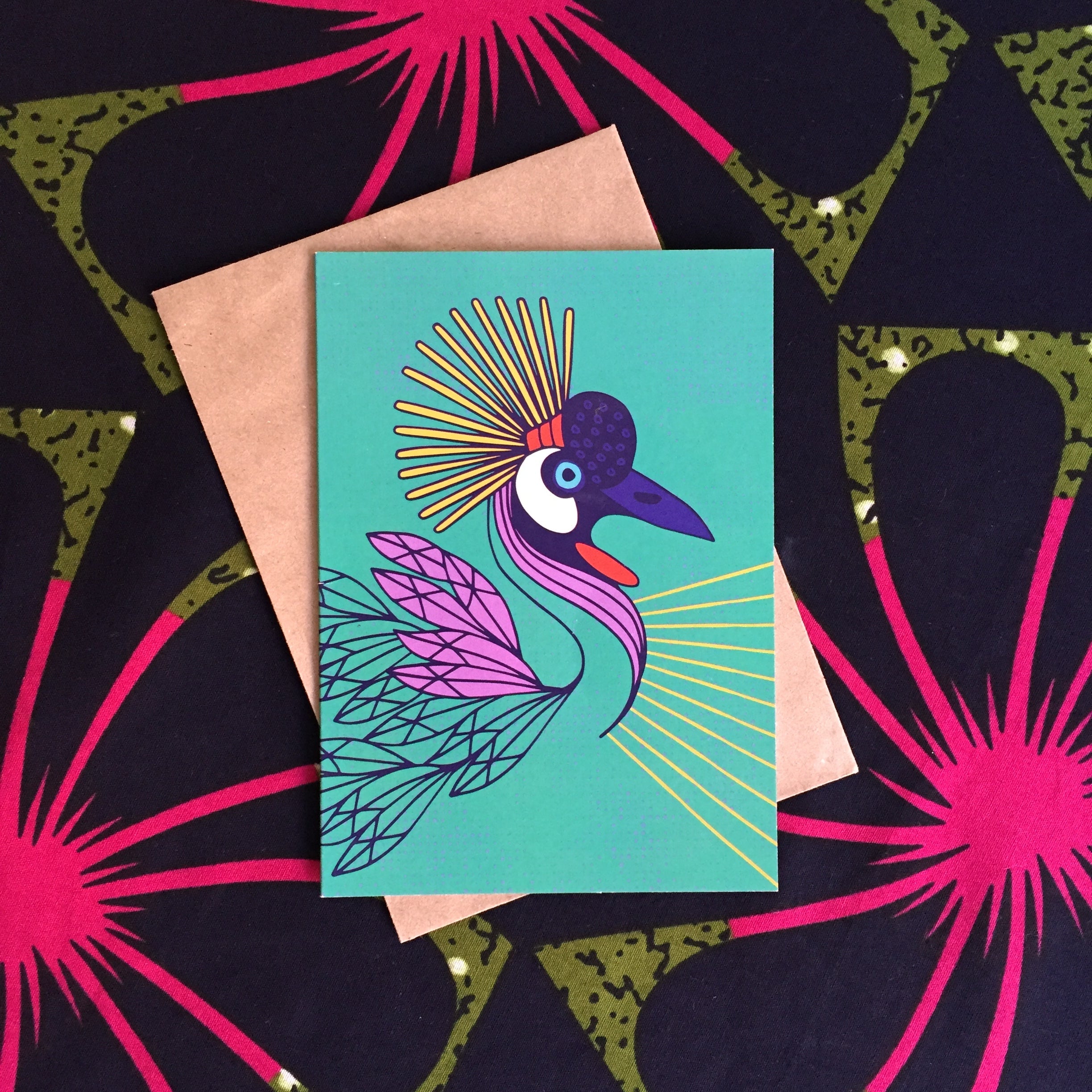 Turquoise colored greeting card with multicolored crane 
