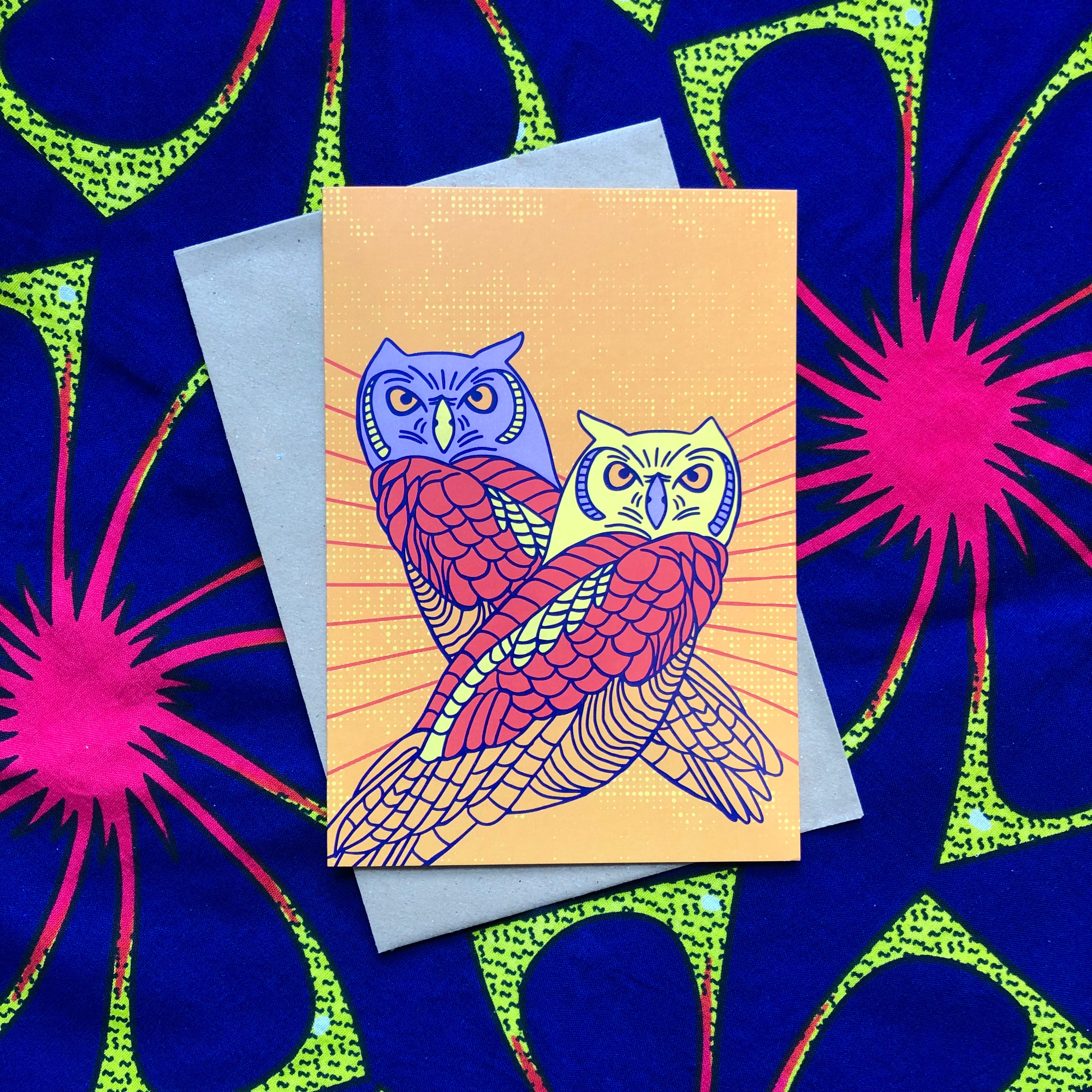 Paster orange greeting card with 2 lavender, yellow red and orange owls