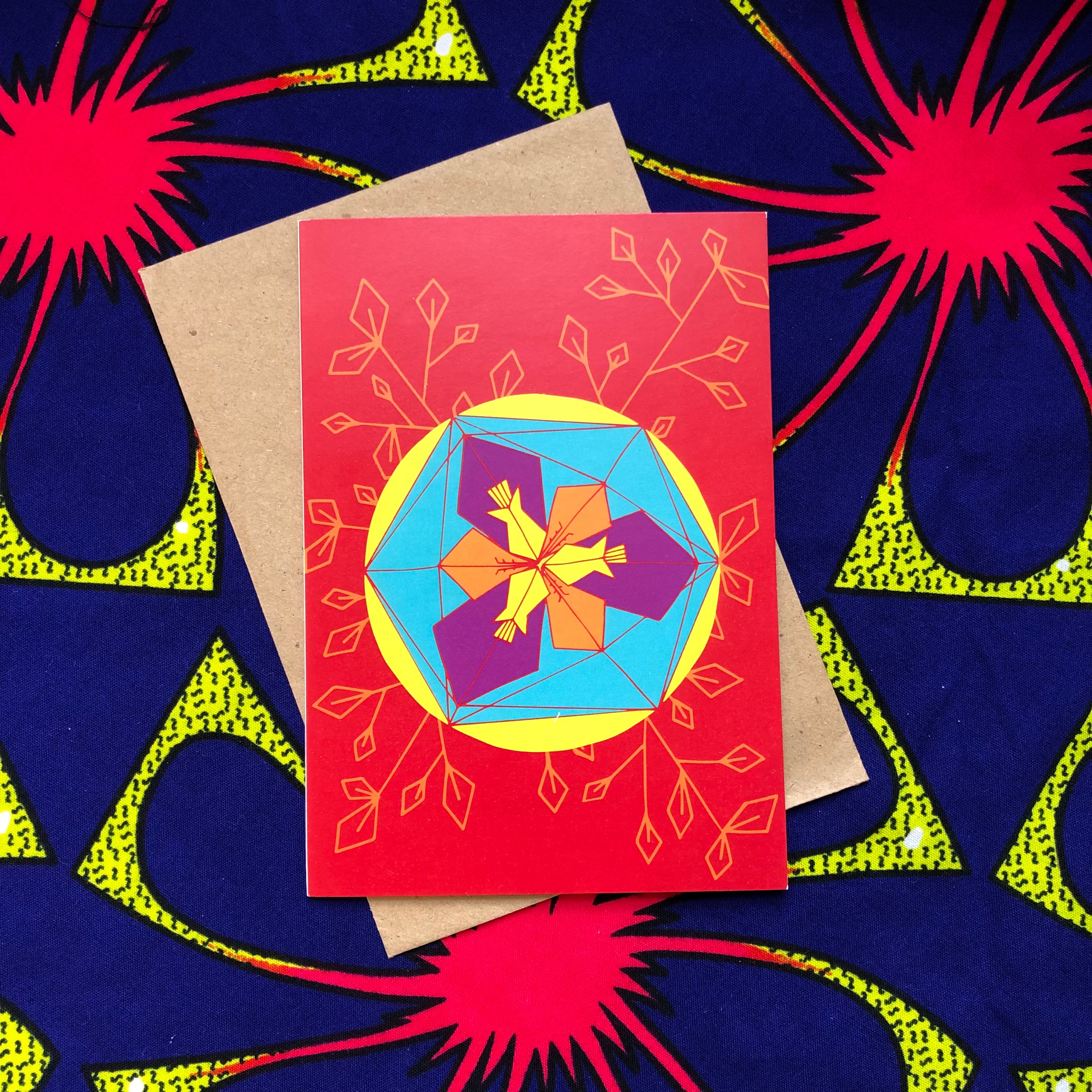 Red greeting card with purple, orange, blue and yellow geometric design.