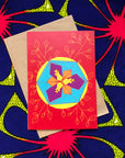 Red greeting card with purple, orange, blue and yellow geometric design.