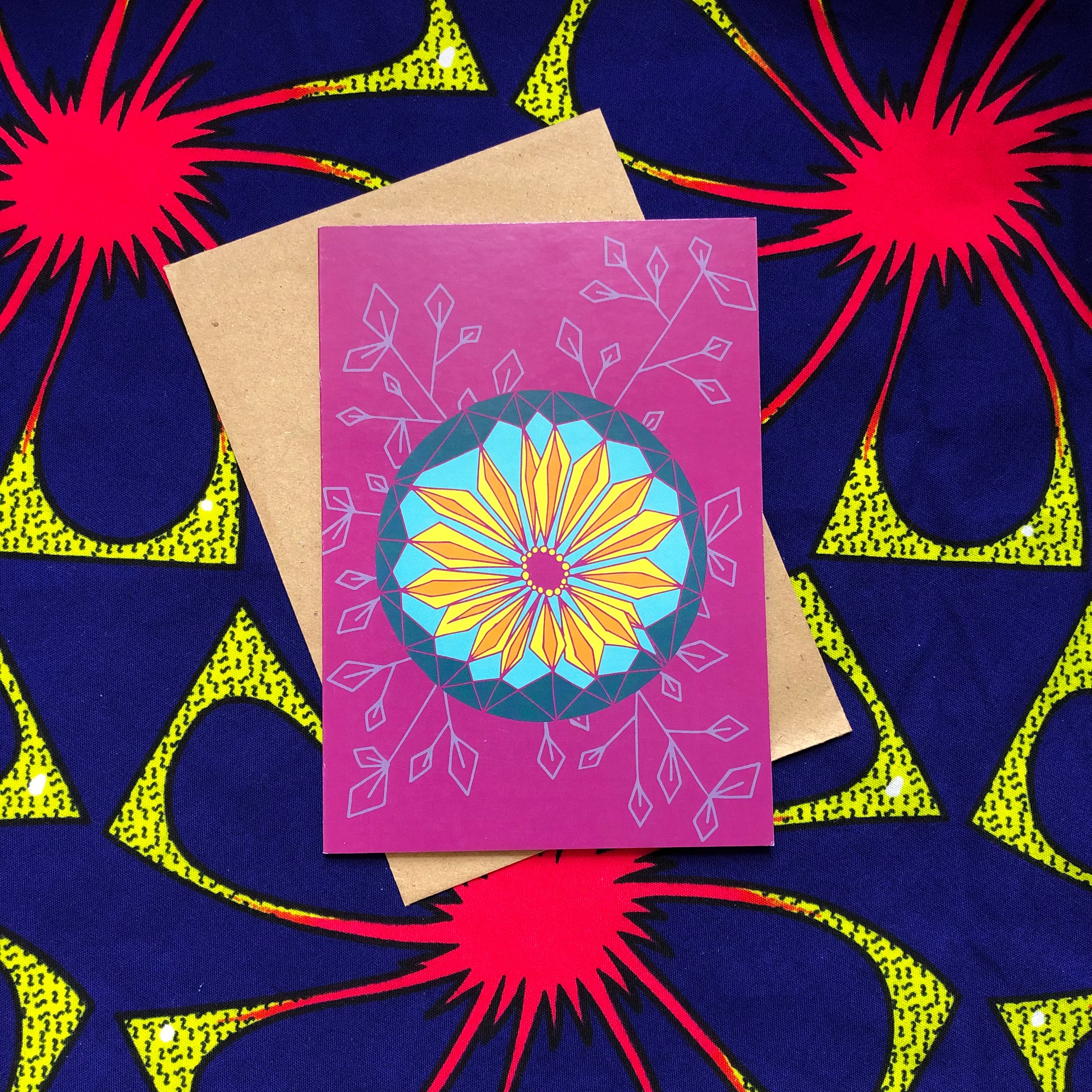 Purple greeting card with geometric yellow and blue design.