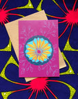 Purple greeting card with geometric yellow and blue design.