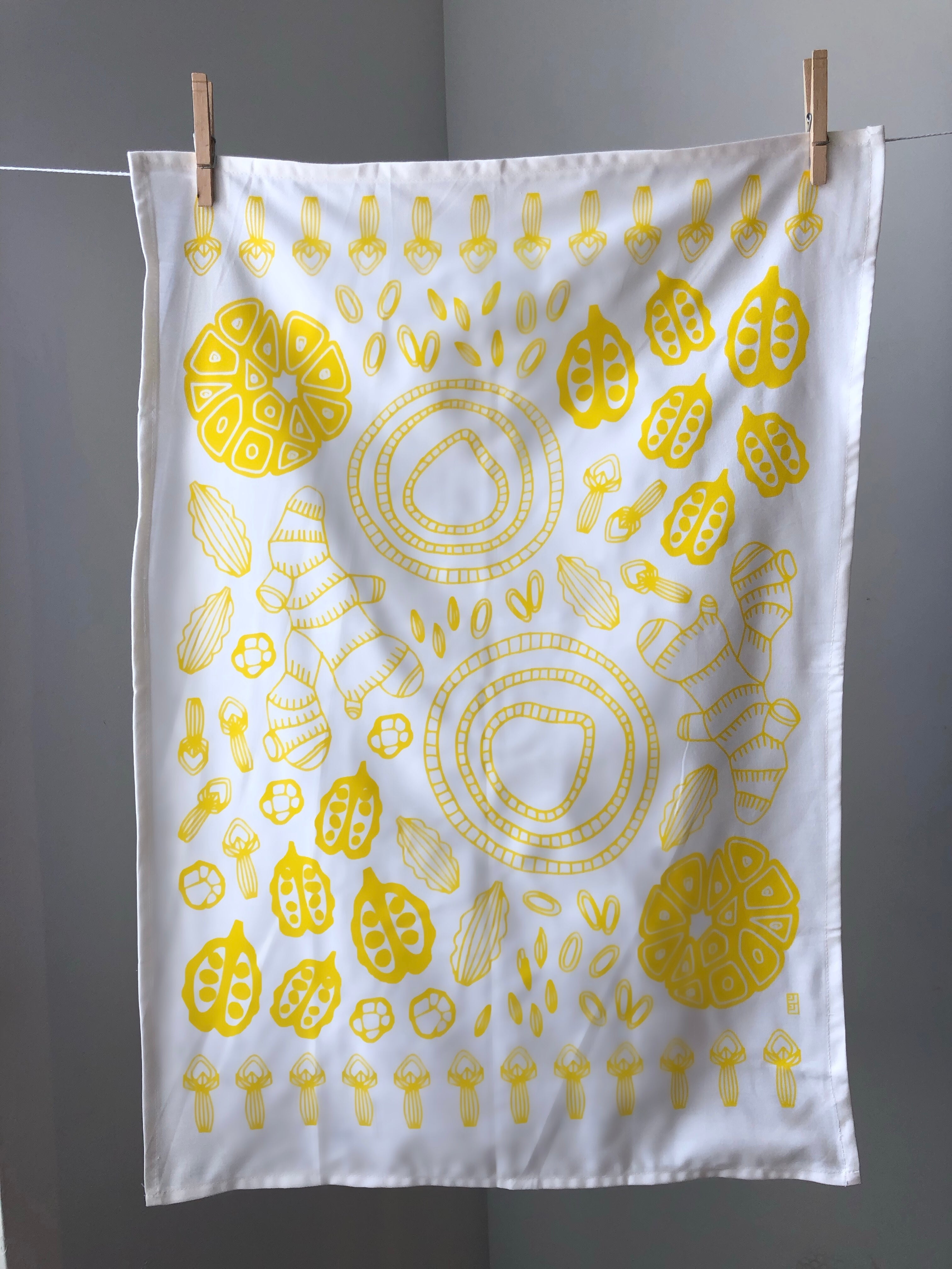 Display of tea towel with vegetable print.
