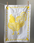 Display of tea towel with rooster print.