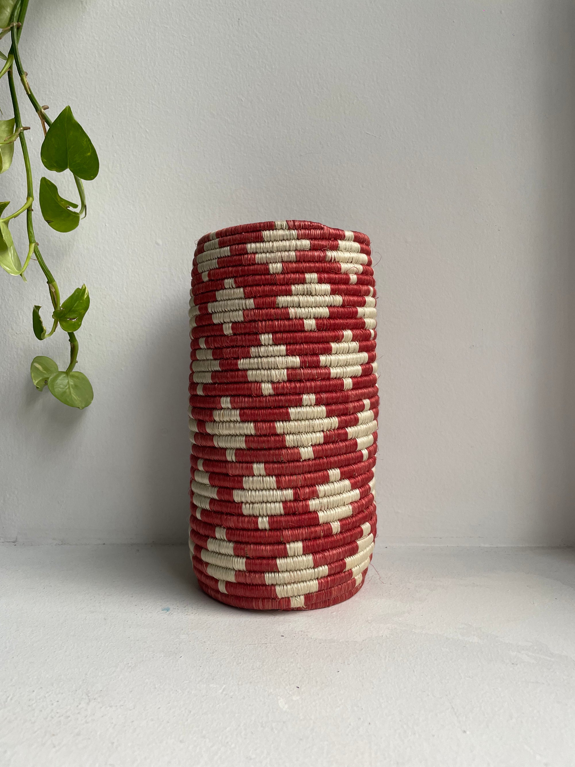 Display of red and beige colored vase