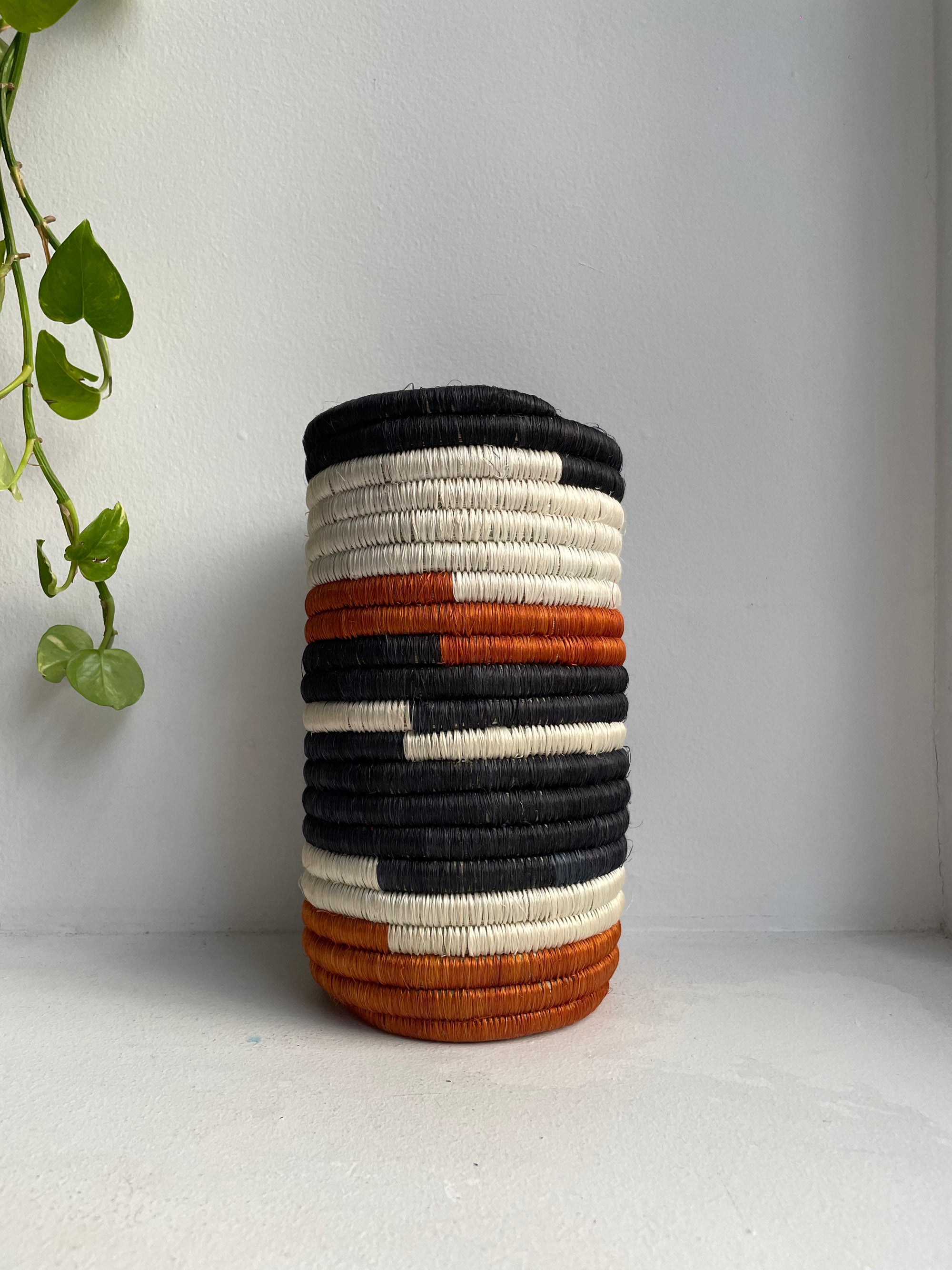 Display of black, white and orange vase