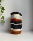 Display of black, white and orange vase