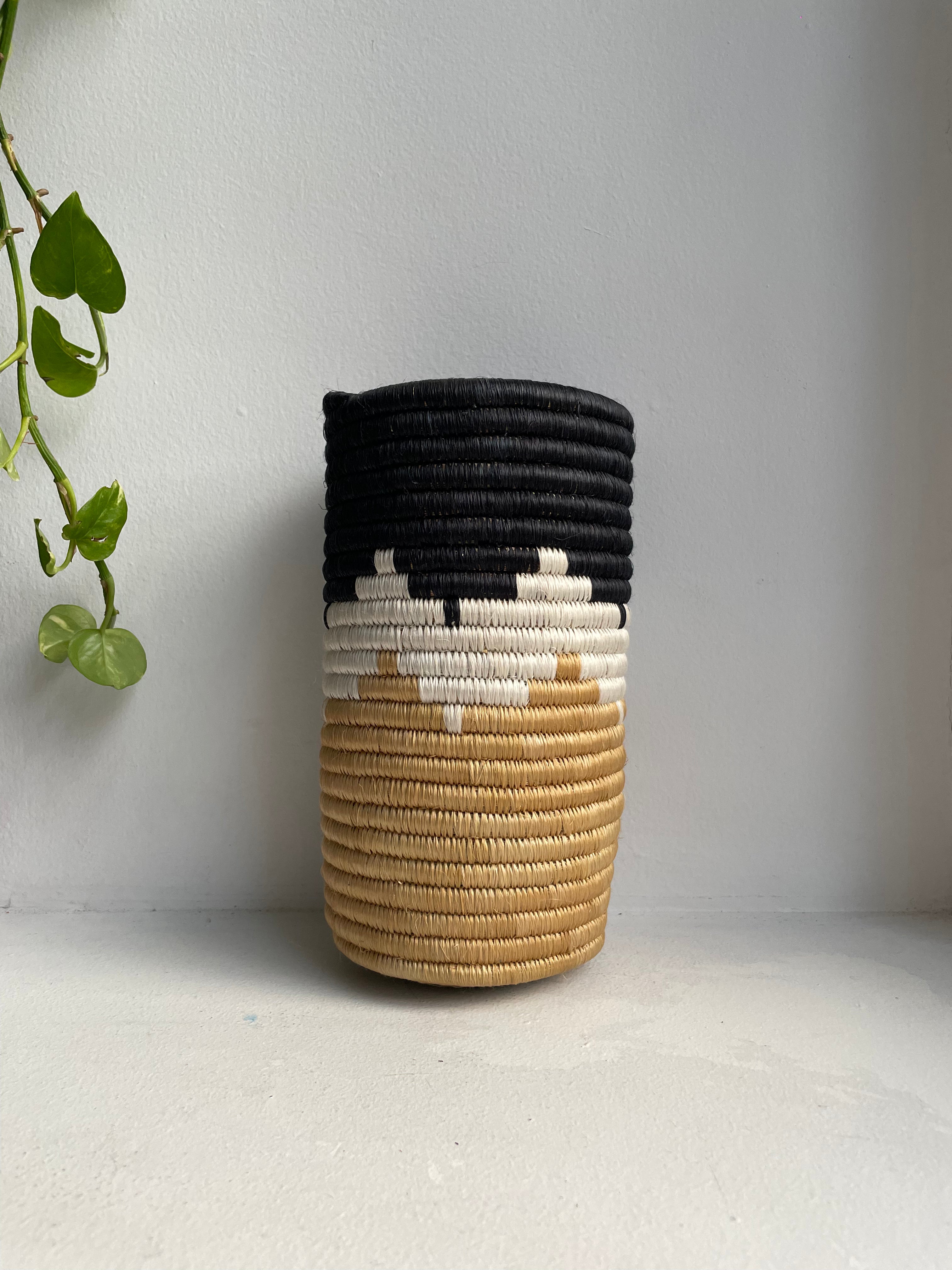 Display of black, white and beige colored vase