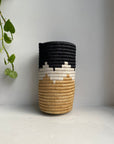 Display of black, white and beige colored vase