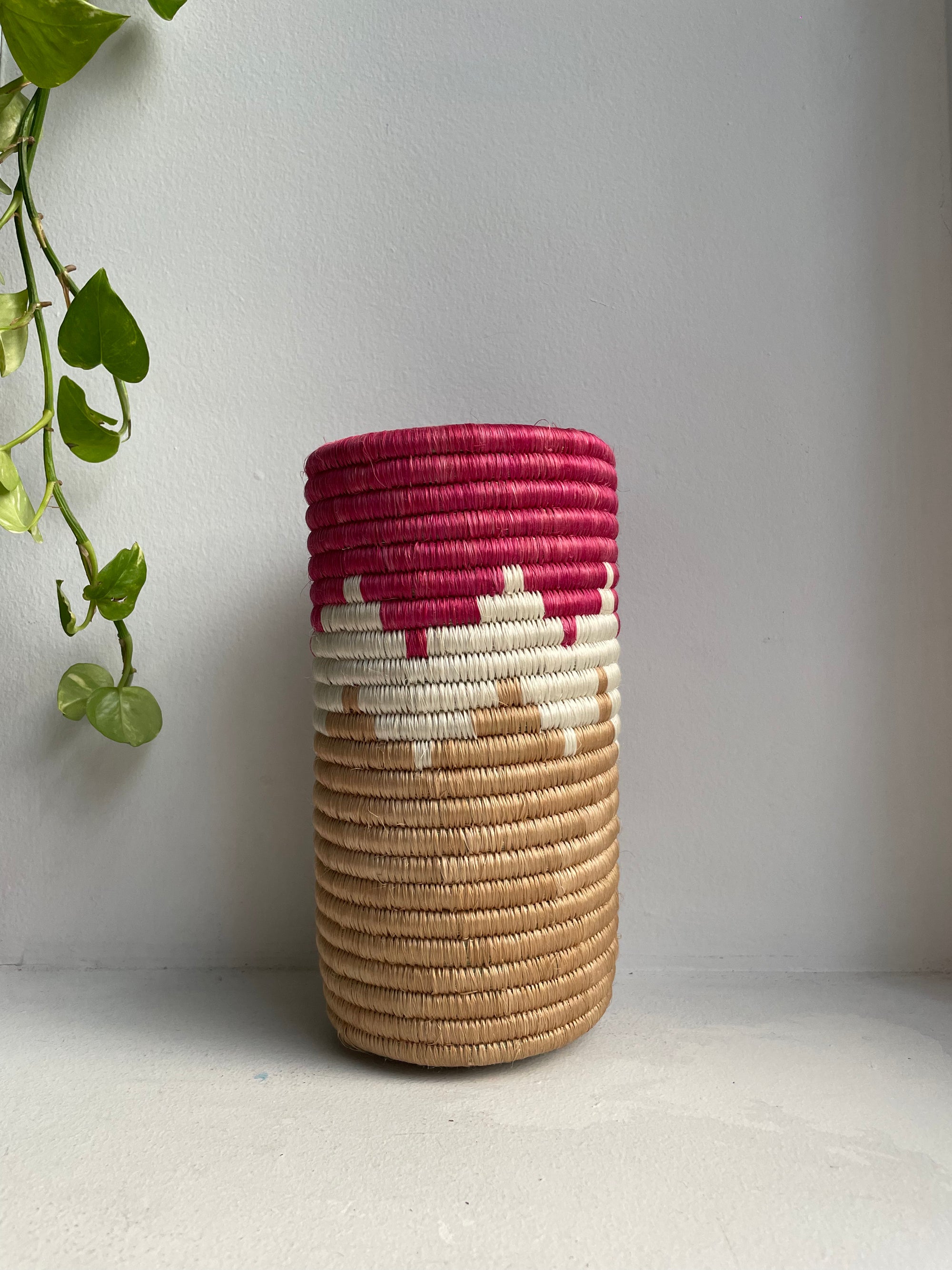 Display of red, white and beige colored vase